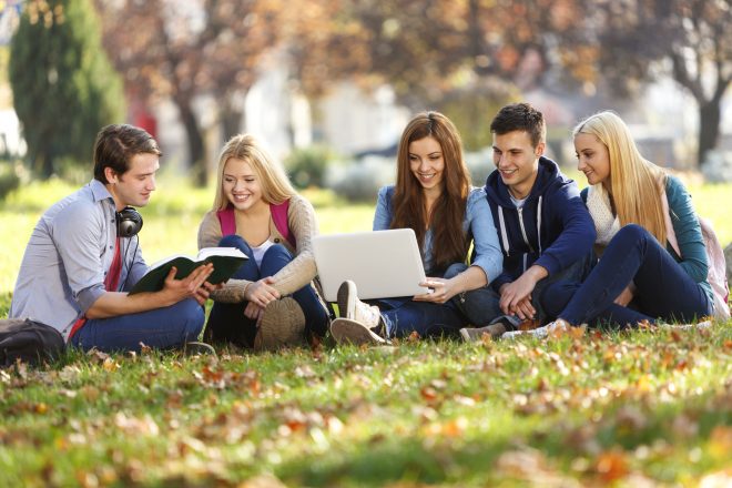 Group of college students studying at campus